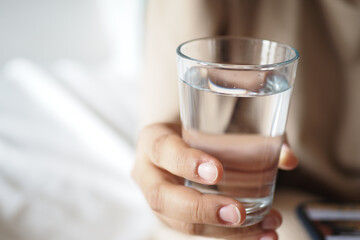 holding a glass of water with copy space 