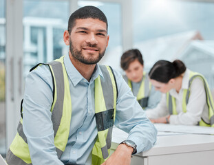 Well get the job done. Cropped portrait of a handsome young male construction worker sitting in a meeting with his colleagues.