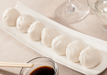 Fototapeta na wymiar Dish of Asian cuisine - dim sum dumplings served on white plate