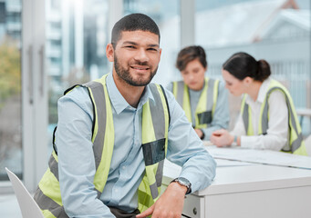 You can trust us with your building project. Cropped portrait of a handsome young male construction worker sitting in a meeting with his colleagues.