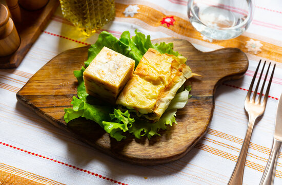 Flia served on lettuce salad leaf on wooden board, popular dish of Albanian and Kosovan cuisine