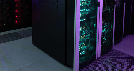 Glowing computer servers in a dark computer server room