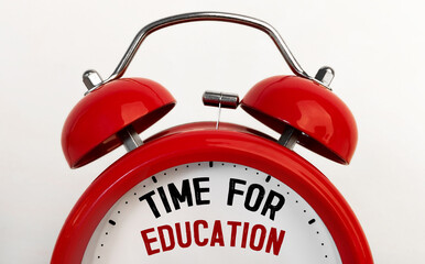 Red alarm clock with text TIME FOR EDUCATION