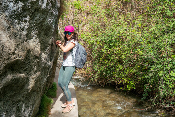 Woman hiking in Los Cahorros, Granada. Narrow pass along the river.
