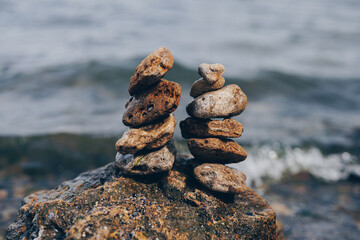 Stack of stones balancing against sea background