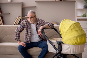 Fototapeta na wymiar Old man looking after newborn at home