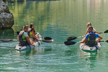 A group of friends enjoying having fun and kayaking while exploring the calm river, surrounding forest and large natural river canyons