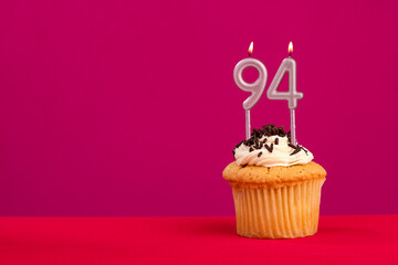 Birthday cake with candle number 94 - Rhodamine Red foamy background