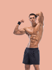 Fototapeta premium Man athlete isolated on a beige background. Gym full body workout. Muscular man athlete in fitness gym have heavy workout. Sports trainer on training. Fitness motivation.