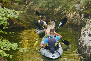 A group of friends enjoying having fun and kayaking while exploring the calm river, surrounding...