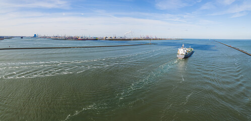aerial panorama of a tanker ship into the sea near Botlek port, Rotterdam, Netherlands. High...