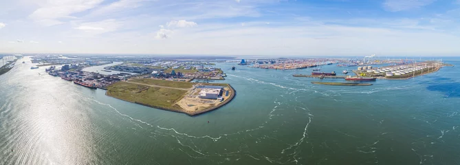 Fotobehang Aerial shot over harbor area, industrial landscape, oil storage containers and tanker ships, blue sky in the background, Maasvlakte, Netherlands. High quality photo © PoppyPix