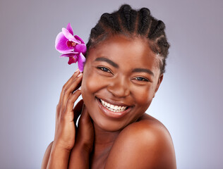 I feel amazing. Studio shot of a beautiful young woman posing with a flower in her hair. © Alexis Scholtz/peopleimages.com