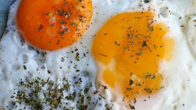 Fried eggs in the plate close up ,