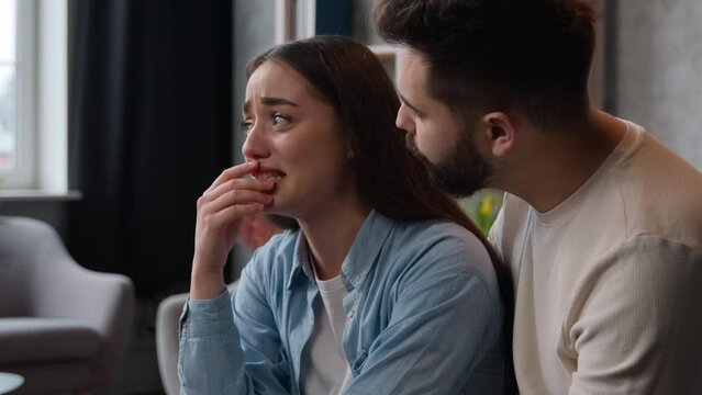 Annoyed angry crying Caucasian woman girlfriend wife shout on man accusing husband for treason breakup relationship divorce quarrel conflict calm boyfriend feel guilty say sorry apologizing at home