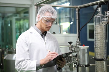 scientist analyzing a biological and ecological hemp plant used for herbal pharmaceutical CBD oil and THC oil in a laboratory.