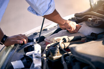 Is there enough water. Cropped shot of an unrecognizable man checking under the hood of his car after suffering a vehicle breakdown.