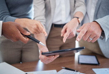 They have so many questions. Cropped shot of a group of unrecognizable businesspeople looking over a tablet in the boardroom.