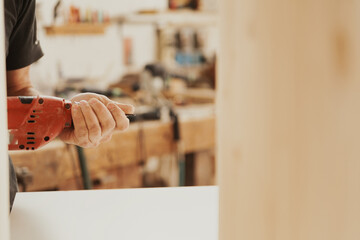 Detail in focus: a red drill used by the woodworker