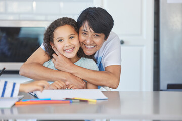 Obraz premium Look at her sweet face. Shot of a grandma helping her granddaughter at the kitchen table at home.