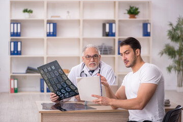 Young male patient visiting old male doctor radiologist