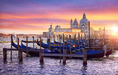 Venice Italy. Gondolas floqting by the docks of Grand Canal in Venezia. Sunset view Cathedral Santa Maria della Salute Picturesque panoramic skyline landscape - 596492583