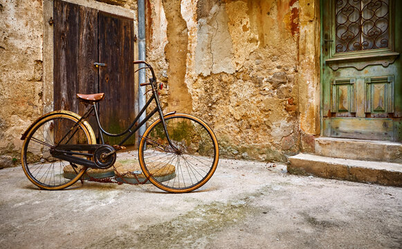 Old retro bicycle on vintage street in Croatia background aged wall and wooden door. City Lovran