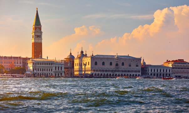 Venice, Italy. Panoramic view from Grand Canal at Saint Mark's Campanile with tower of Venezia. Scenic venice sunset clouds on the sky
