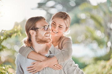 Behind every man is a woman who supports him. Shot of a young couple spending time together in the garden at home.