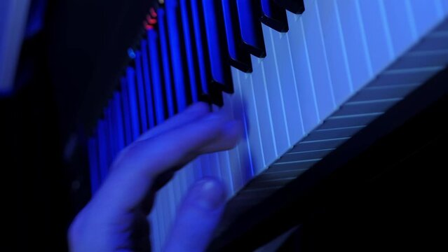 Pianist playing on electric keys in sound music studio. Vertical video