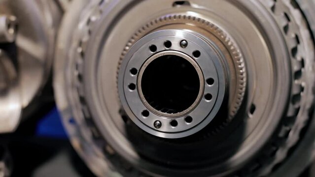 Gear mechanism process Rotating gears. works from within. movable clutch disc. Close-up.