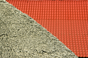 abstract geometric texture of red tiles and thatched roof in the background.