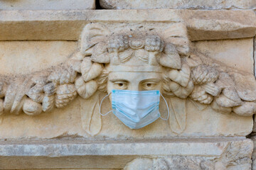Relief sculptures with wearing medical masks in the ancient city of Aphrodisias. Turkey