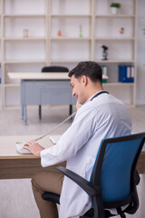 Young male doctor in telemedicine concept