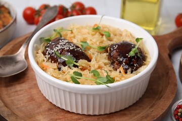 Bowl with sauerkraut and chicken on table, closeup