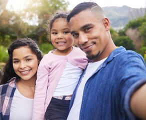 Family means we stick with each other through everything. Shot of a young family happily bonding together outside.