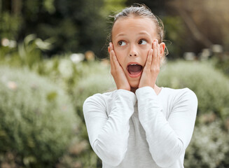 I didnt see that coming. Shot of an adorable little girl looking surprised while standing outside.