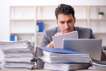 Young male employee working in the office