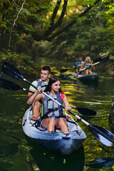A group of friends enjoying having fun and kayaking while exploring the calm river, surrounding forest and large natural river canyons