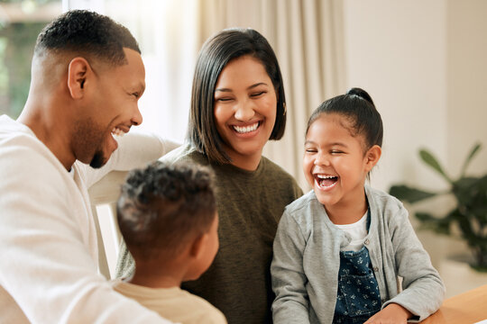 They Love Just Chilling With Mom And Dad. Shot Of A Young Family Bonding Together At Home.