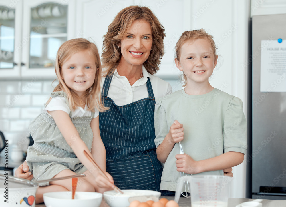 Wall mural Im showing them all my golden recipes. Portrait of a grandmother baking with her two granddaughters at home.