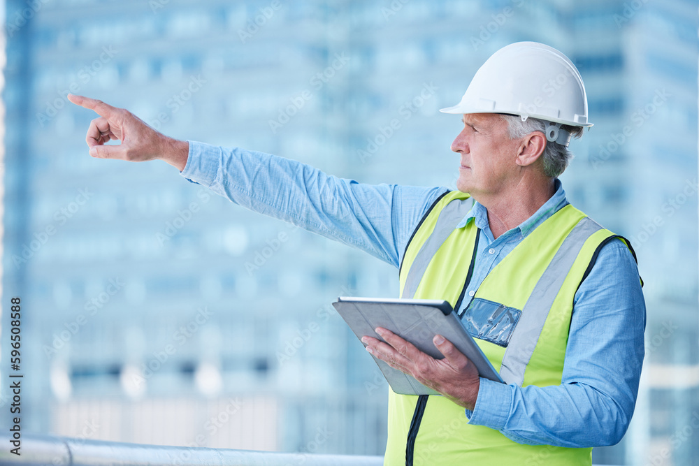 Poster creating my own world. shot of a mature male foreman using his digital tablet on site.