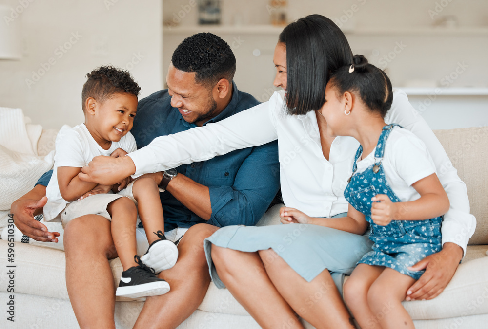 Canvas Prints A family takes care of their own. Shot of a young family happily bonding together on the sofa at home.