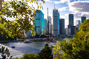 panorama of brisbane city as seen from the top of famous kangaroo point cliffs; brisbane cbd by the river during sunny day; business district in brisbane, queensland, australia - obrazy, fototapety, plakaty