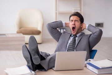 Young male employee working in the office