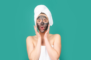 Facial charcoal mask. Cosmetics, cosmetology, dermatology. Woman face with black clay mask. Cosmetic procedure womans face in the mask on face.