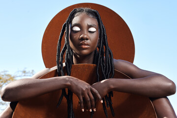 I love with her heritage. Cropped shot of an attractive young woman posing outside.