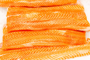 Chilled salmon fillet on ice. Healthy food and vitamins. Close-up.