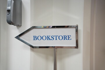 Bookstore sign inside the school or university. Bookstore arrow signs with white base paper and...