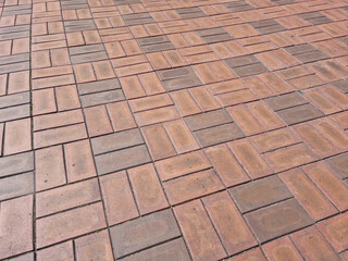 close up textured red brick walkway.